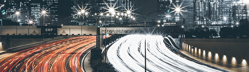 An urban motorway with a time lapse image of speeding traffic